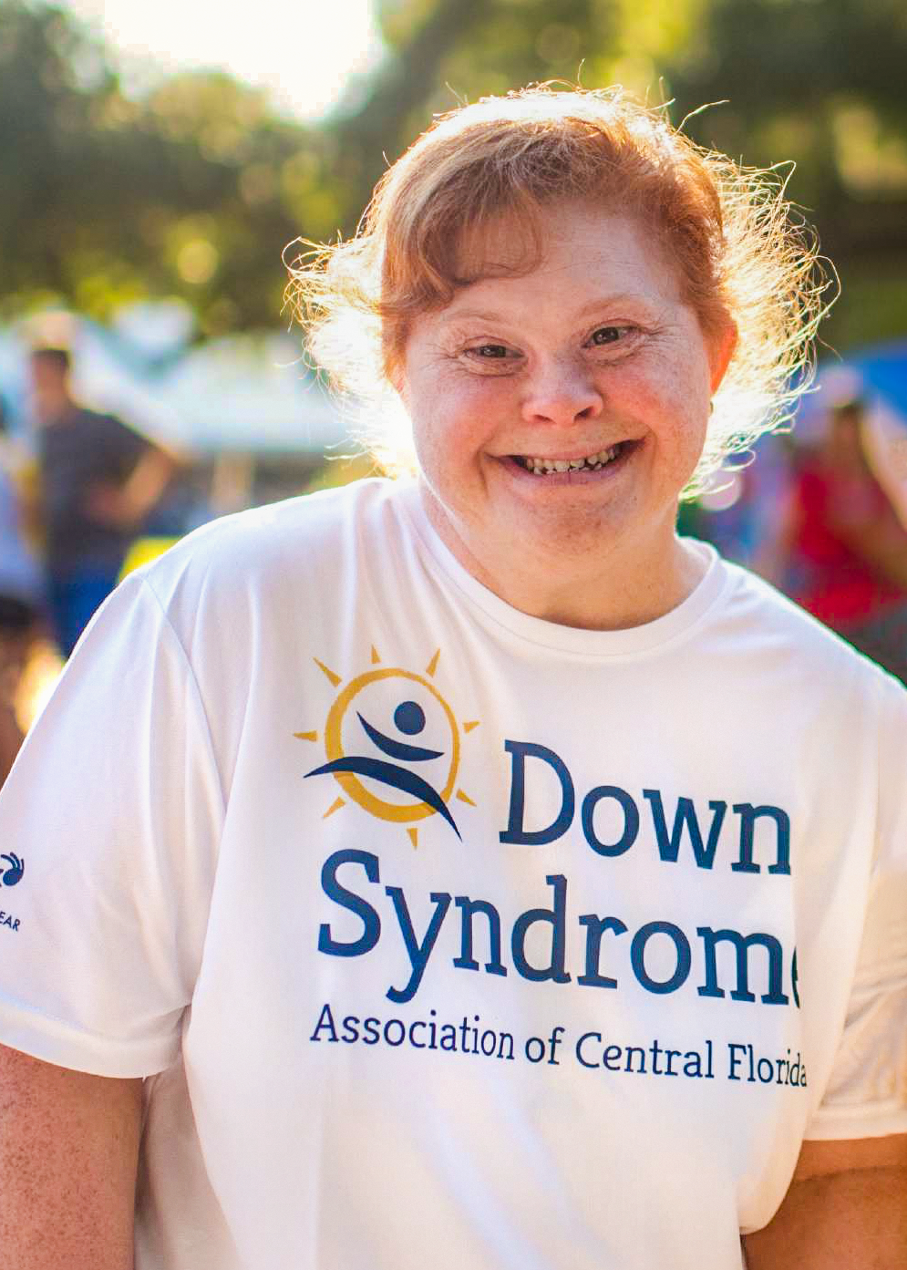 Adult wearing Down Syndrome Shirt, smiling